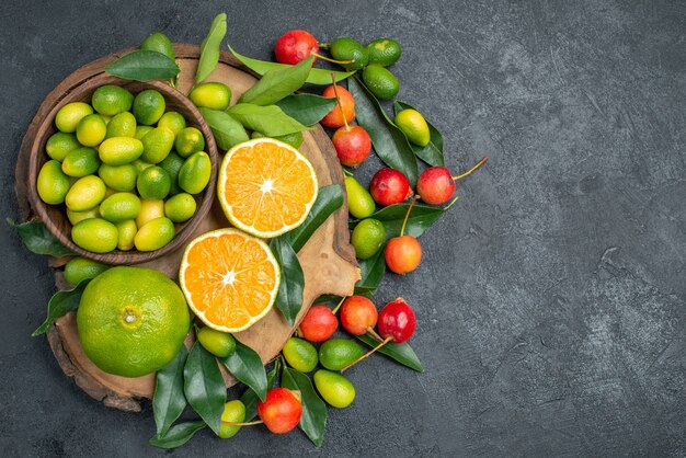 Top vue rapprochée fruits la planche à découper avec des agrumes avec des feuilles