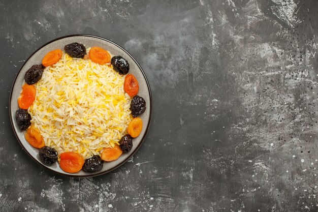 Top vue rapprochée riz riz et fruits secs dans l'assiette