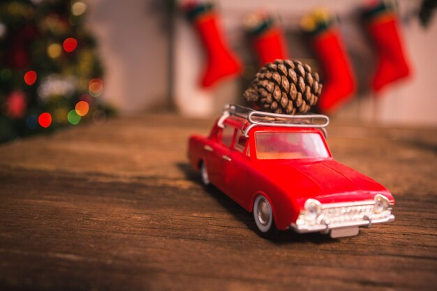 Toy voiture rouge avec une pomme de pin sur le dessus