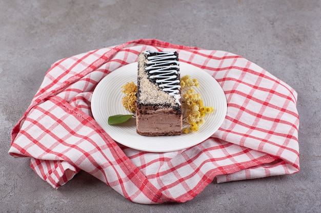 Tranche de gâteau au chocolat sur plaque blanche