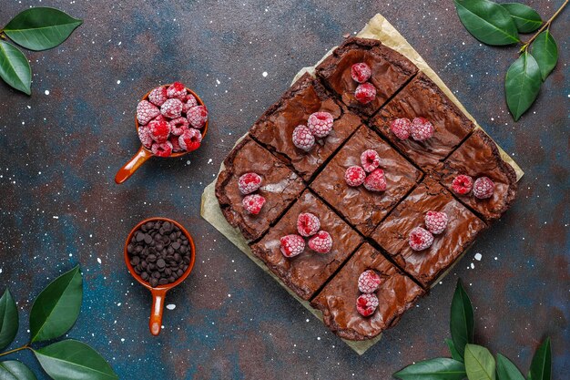 Tranches de dessert au gâteau brownie au chocolat avec framboises et épices, vue de dessus