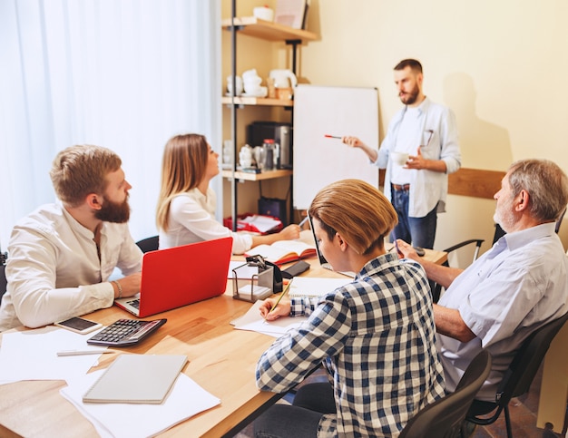 Photo gratuite travail d'équipe. photo de jeunes hommes d'affaires travaillant avec un nouveau projet au bureau