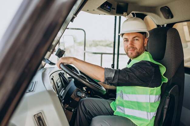 Travailleur masculin avec bulldozer dans la carrière de sable