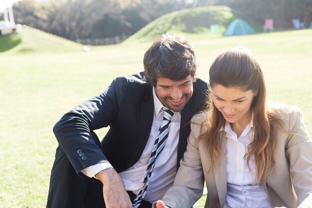 Les travailleurs assis sur l&#39;herbe et regarder quelque chose