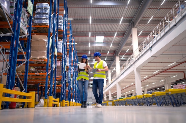 Travailleurs d'entrepôt travaillant ensemble à l'organisation de la distribution des marchandises sur le marché