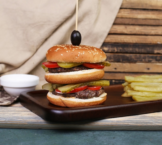 Triple hamburger avec viande et légumes.