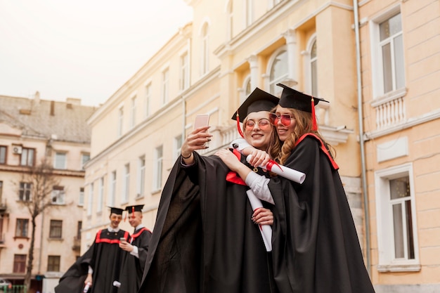 Étudiants étreignant et prenant des photos