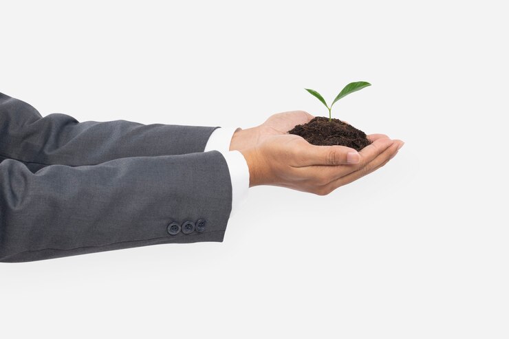 Photo gratuit ventouses à la main de la terre végétale pour sauver l'environnement
