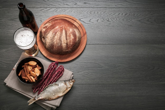 Verre à bière plat poser et bouteille avec plateau de nourriture avec espace de copie