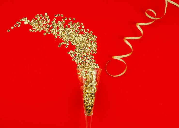 Photo gratuit verre de champagne et paillettes d'or