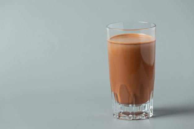 Verre de lait au chocolat sur la surface sombre.