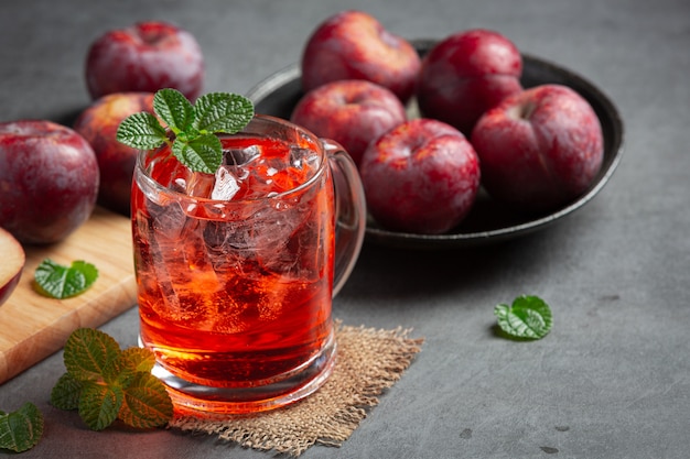 verre de prune posé sur un sol sombre