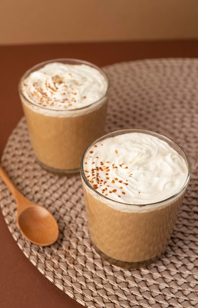 Photo gratuite verres à café avec crème fouettée sur table