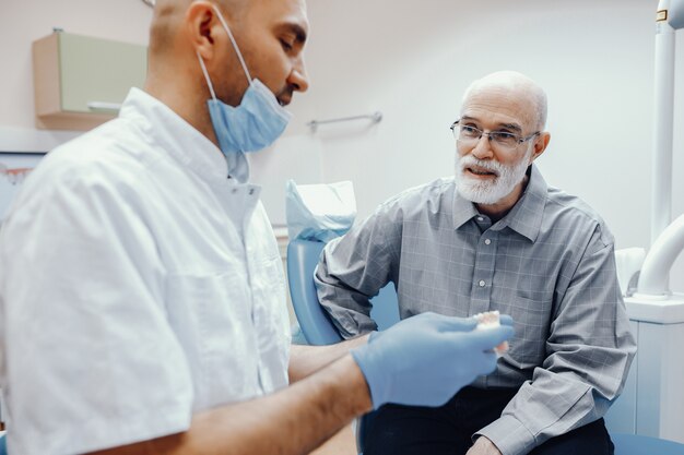 Vieil homme assis dans le bureau du dentiste