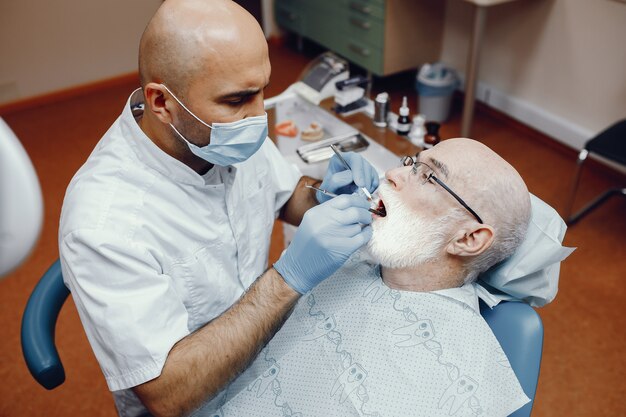 Vieil homme assis dans le bureau du dentiste