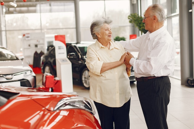 Vieux couple élégant dans un salon de voiture