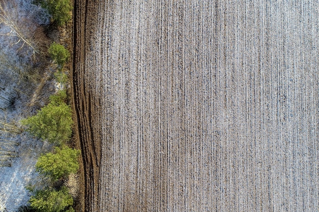 Vue aérienne d'un champ agricole avec des gouttes de neige dans la campagne