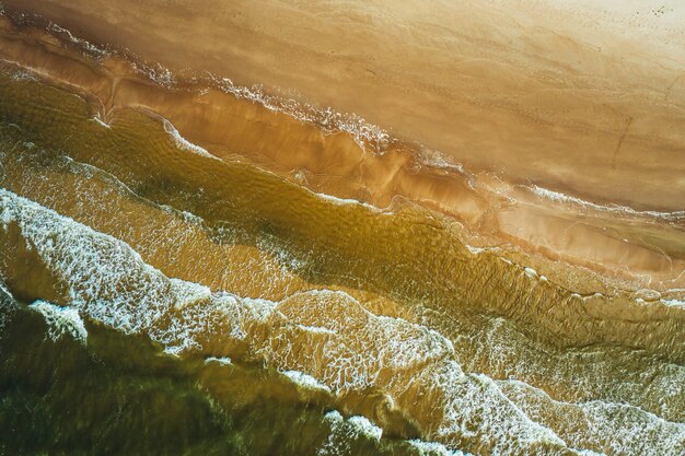 Vue aérienne de la vague de l'océan atteignant le littoral