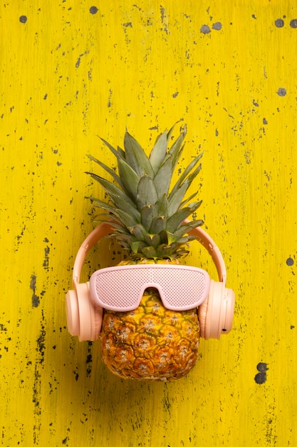 Vue d'ananas avec des lunettes de soleil et des écouteurs sympas