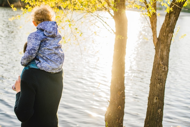 Vue arrière du père avec son fils sur ses épaules