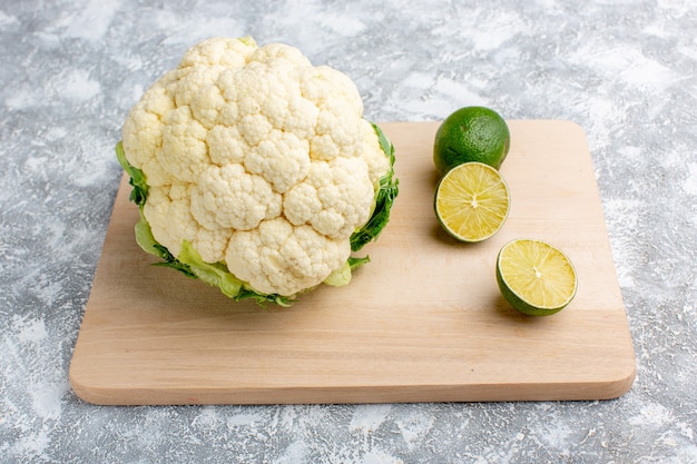 Photo gratuite vue avant du chou-fleur frais avec du citron sur un bureau gris rustique en bois