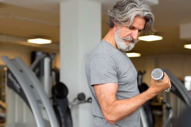 Vue de côté homme formation au gymnase