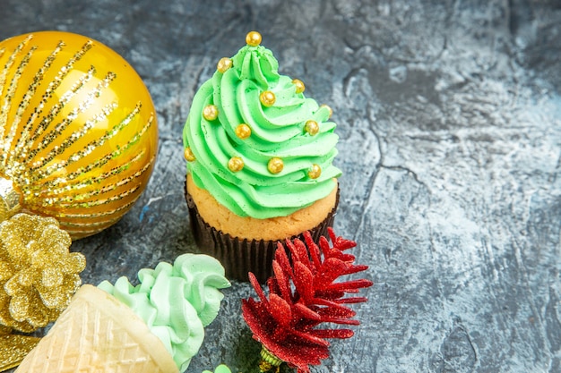 Vue de dessous arbre de Noël cupcake glaces ornements de Noël sur fond gris place libre