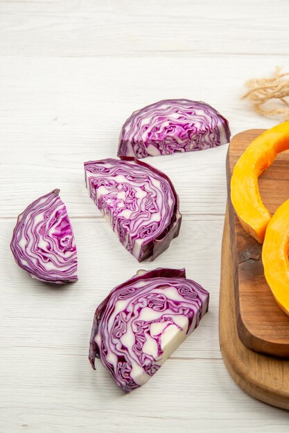 Vue de dessous de la courge de chou rouge hachée sur des planches à découper sur une table grise