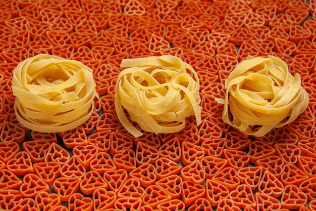 Vue de dessous des tagliatelles sur des pâtes italiennes en forme de coeur rouge