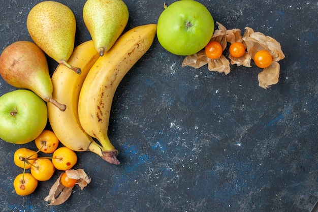 Photo gratuite vue de dessus bananes jaunes paire de baies avec des pommes vertes fraîches poires sur le bureau bleu foncé fruit berry fresh vitamine sweet
