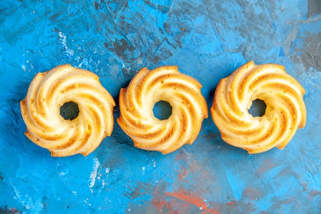 Vue de dessus des biscuits de rangée horizontale sur la surface bleue