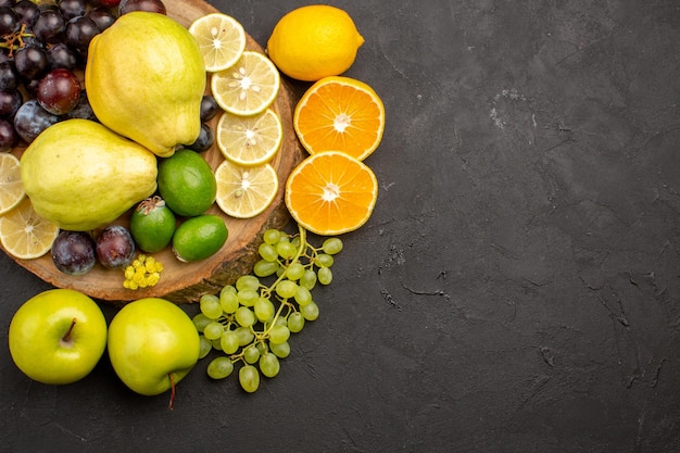 Vue de dessus composition de fruits frais tranchés et mûrs sur un bureau sombre fruits mûrs frais moelleux santé