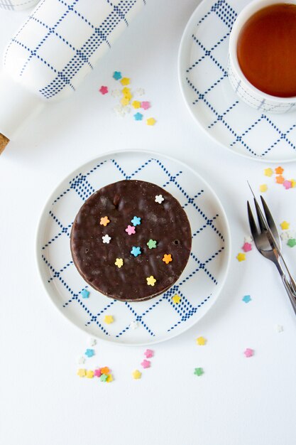 Vue de dessus des cookies aux pépites de chocolat sur une assiette avec une tasse de thé