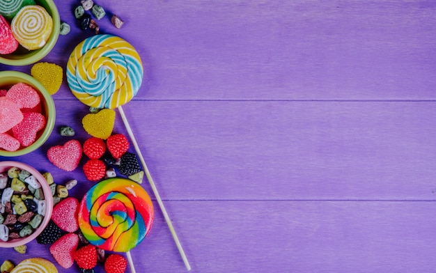 Photo gratuite vue de dessus copie espace marmelade multicolore avec pierres de chocolat et glaçons colorés dans des soucoupes pour confiture sur fond violet