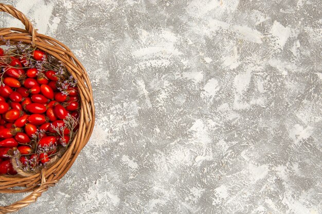 Vue de dessus cornouiller aigre frais à l'intérieur du panier sur le bureau blanc fruit berry vitamine aigre doux arbre plante sauvage