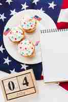 Photo gratuite vue de dessus des cupcakes avec date et drapeau américain