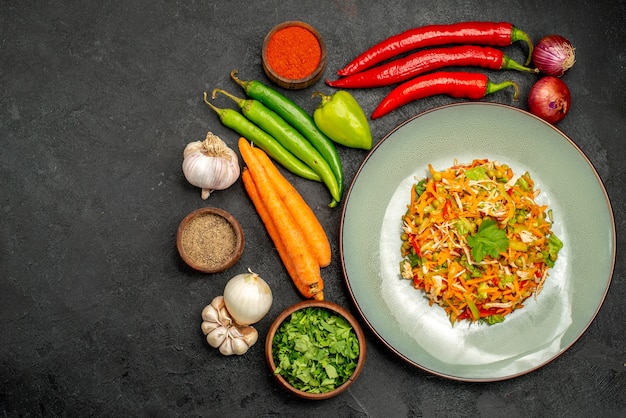 Vue de dessus une délicieuse salade avec des légumes frais sur une table sombre régime alimentaire salade santé