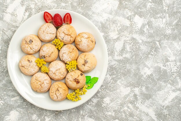 Vue de dessus de délicieux biscuits au sucre à l'intérieur de la plaque sur le fond blanc biscuit au sucre biscuit sucré gâteau au thé