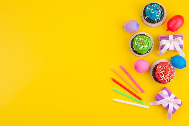 Une vue de dessus de délicieux brownies au chocolat à base de bonbons et de boules sur jaune, couleur biscuit gâteau bonbon