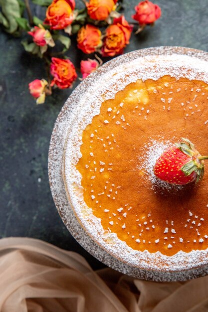 Vue de dessus délicieux gâteau au miel avec du sucre en poudre sur une surface sombre de planche de bois ronde