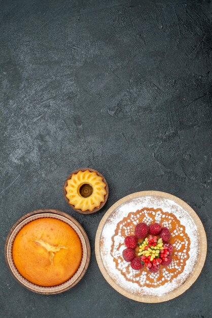 Vue de dessus délicieux gâteau avec sucre en poudre et framboises sur fond gris gâteau tarte aux fruits biscuit sucré