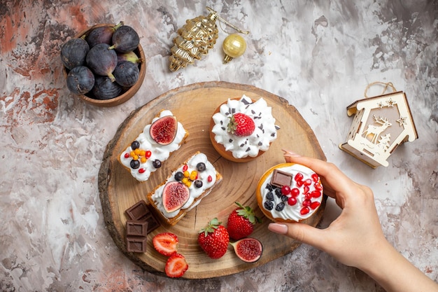 Vue de dessus de délicieux gâteaux avec des fruits frais sur fond clair