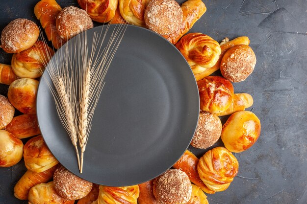 Vue de dessus de délicieux petits pains sucrés sur fond sombre