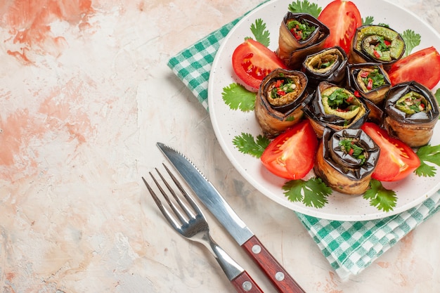 Photo gratuite vue de dessus de délicieux rouleaux d'aubergines avec tomates et légumes verts