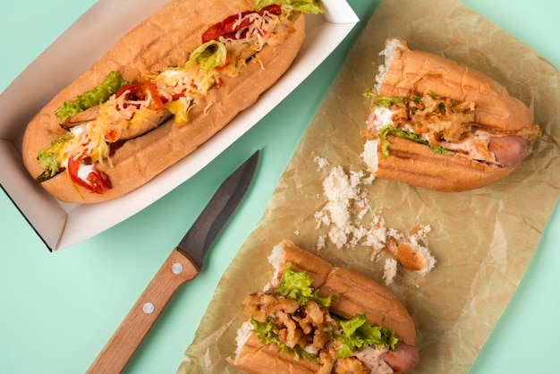 Photo gratuite vue de dessus de deux hot dogs avec couteau