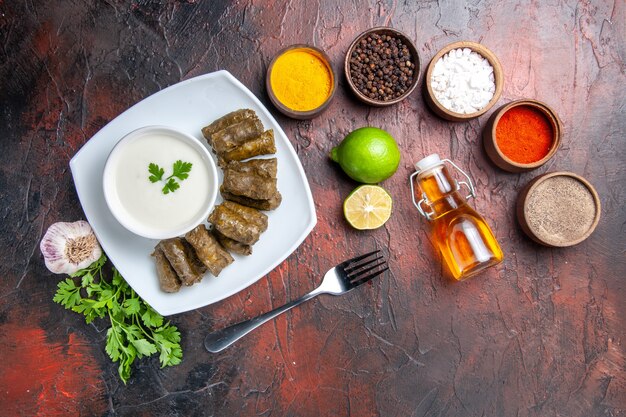 Vue de dessus du dolma feuille verte avec assaisonnements sur la surface sombre