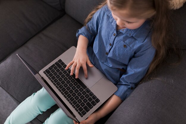 Vue de dessus de la fille utilisant un ordinateur portable