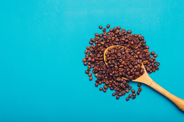 Vue de dessus des grains de café dans une cuillère en bois