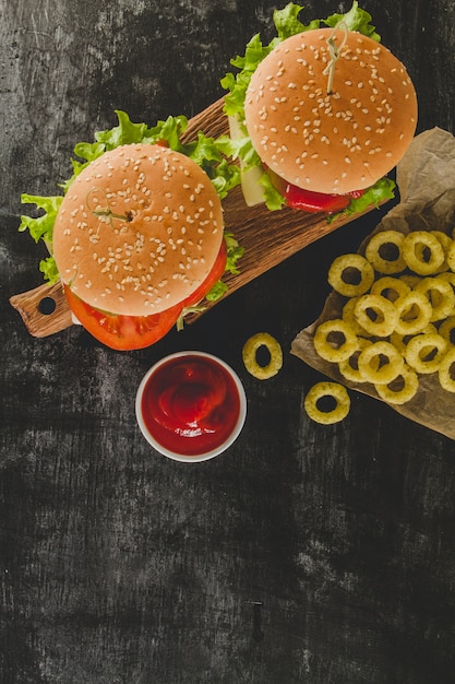 Vue de dessus des hamburgers savoureux et des anneaux d&#39;oignons frits