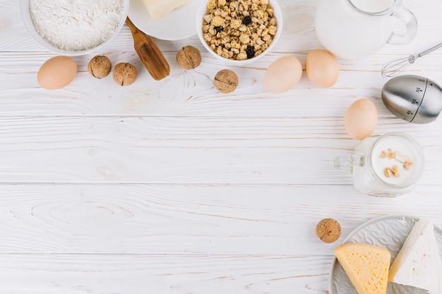 Vue de dessus des ingrédients d&#39;aliments sains et des outils sur une table en bois blanche